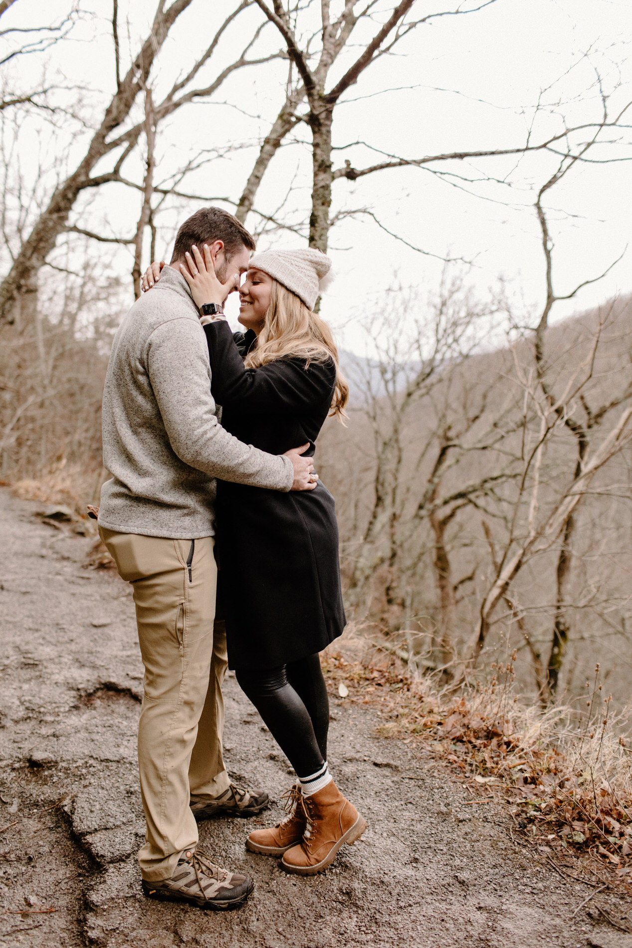 Couples portraits while hiking down the mountain after getting engaged in front of the waterfall at Laurel Falls in the Smoky Mountains.