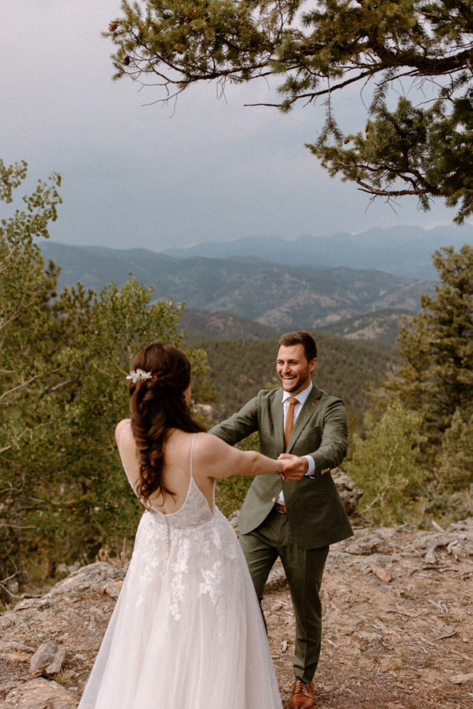 North Star Gatherings is one of the best Colorado wedding venues. The bride and groom share their first look with the mountains in the backdrop.