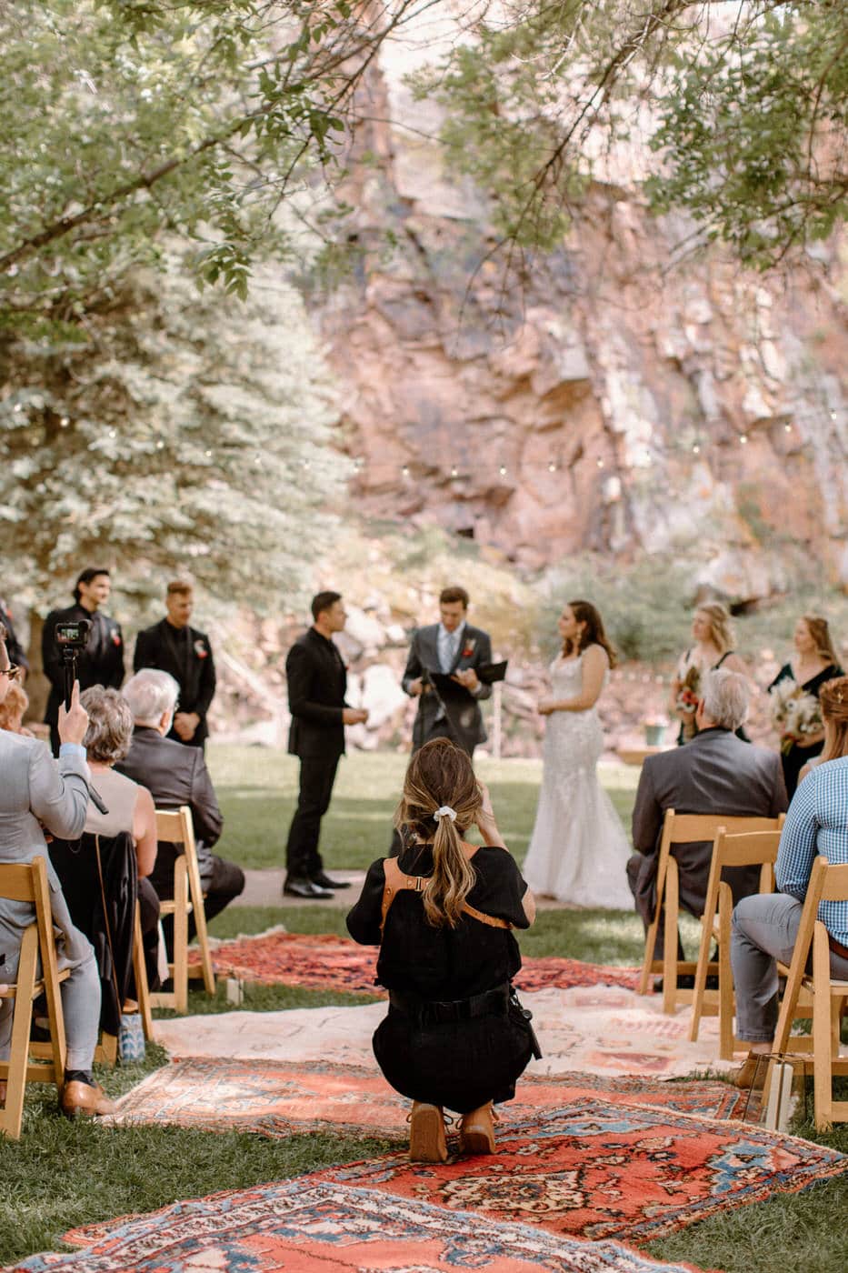 Colorado wedding photographer capturing emotional vows during the ceremony with a Persian rug aisle.