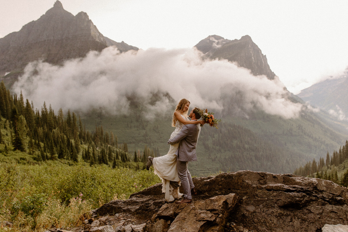 Man and woman sharing embrace after their elopement in Glacier National Park, Montana.