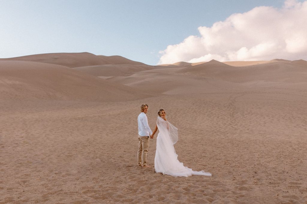 Man and woman eloping in the great sand dunes of Colorado