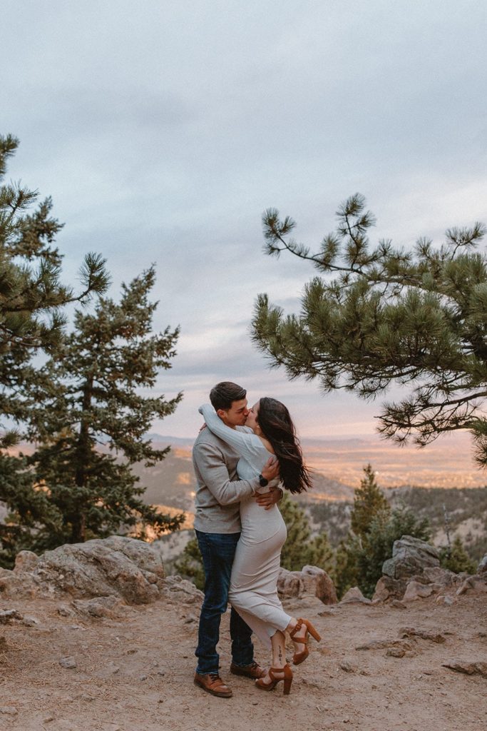 man and woman hugging and kissing at their Lost Gulch Overlook Sunrise Engagement Session