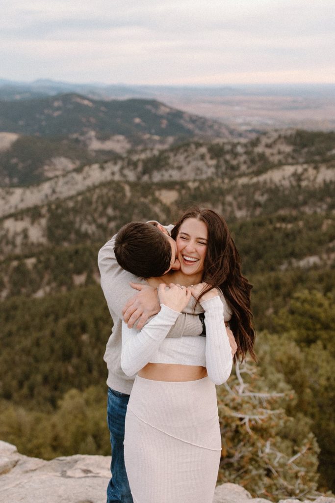 man hugging woman from behind at their Lost Gulch Overlook Sunrise Engagement Session