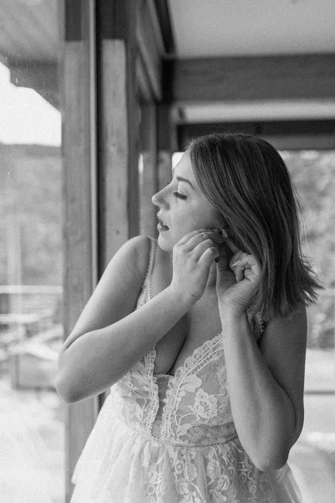 woman putting on her earrings for her Garden of the Gods Elopement 