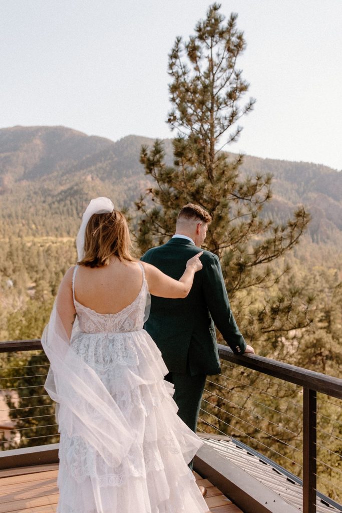 woman tapping man on the shoulder for a first look on their Garden of the Gods Elopement day