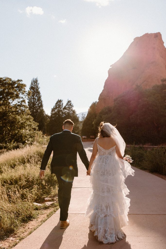 man and woman walking along a path for their Garden of the Gods Elopement 