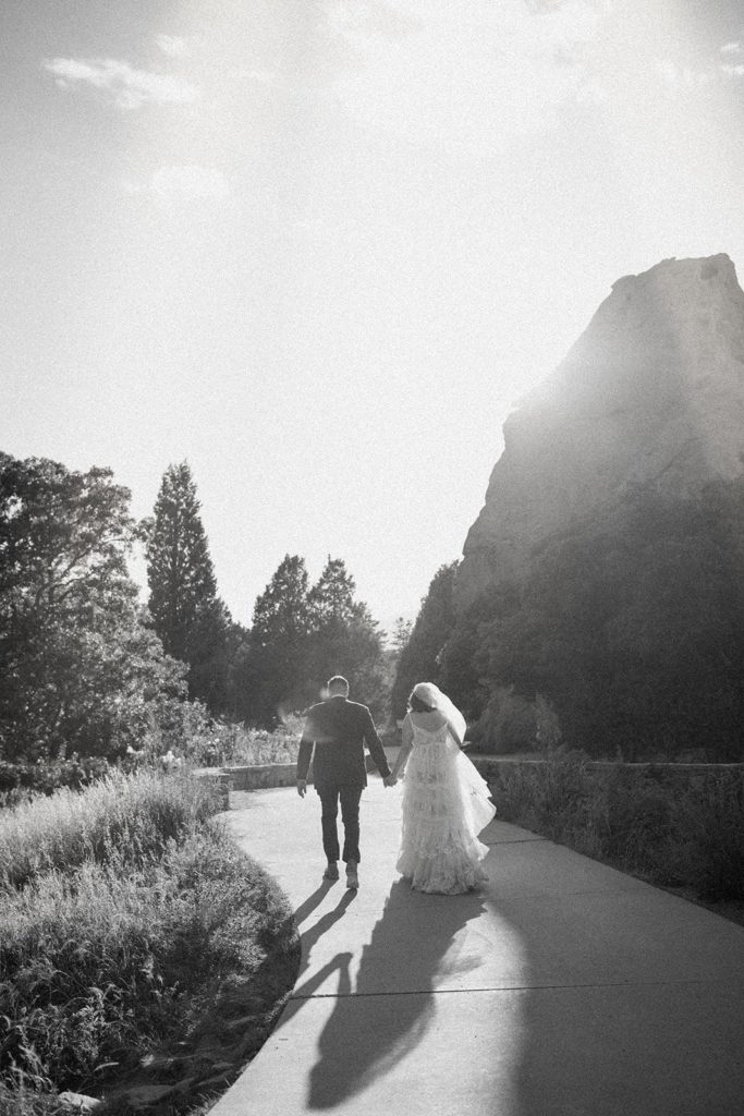 man and woman walking on a path for their Garden of the Gods Elopement 