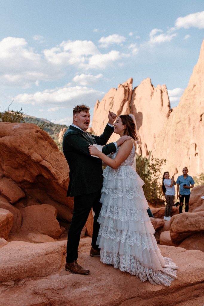 husband and wife cheering as they are pronounced husband and wife on their Garden of the Gods Elopement day