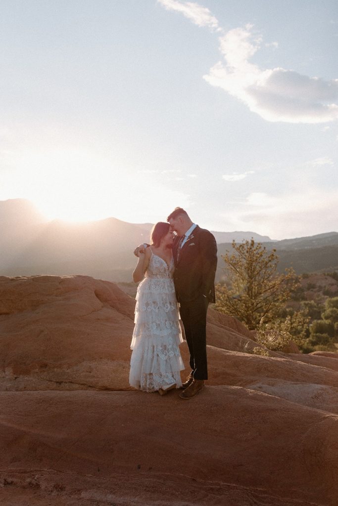 man and woman face to face embracing for their Garden of the Gods Elopement 