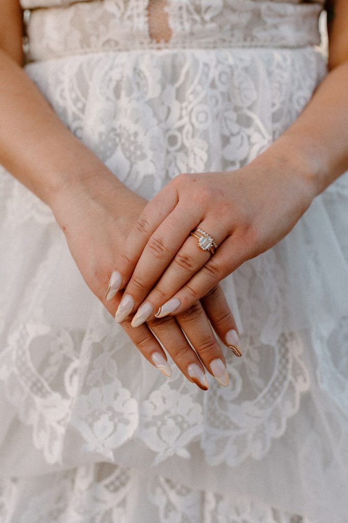 woman&#039;s hands in front of her wedding dress on her Garden of the Gods Elopement day