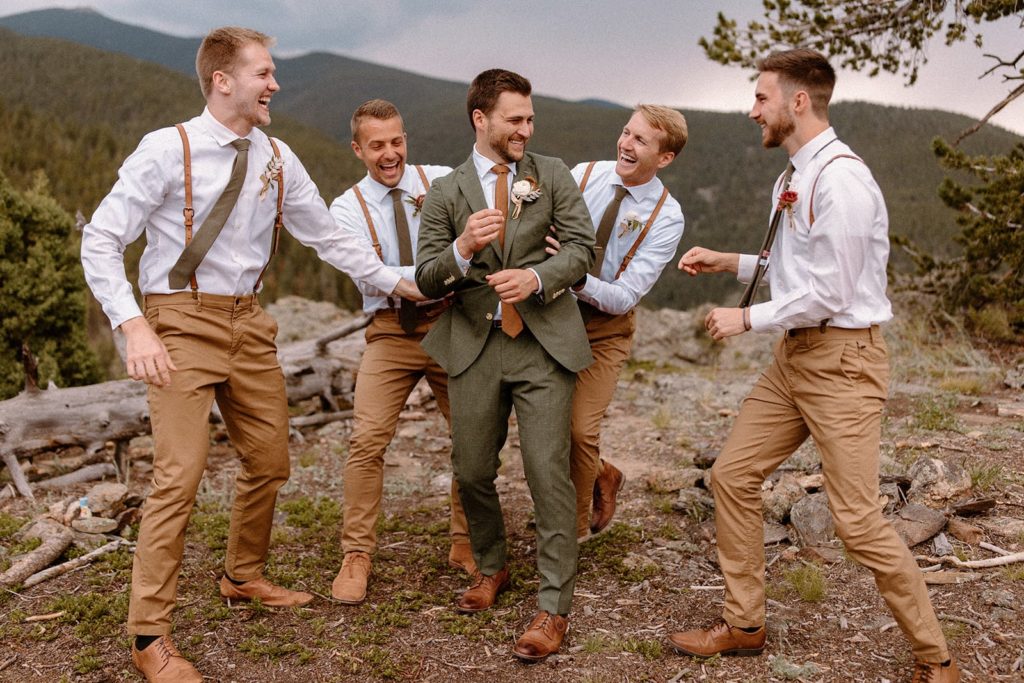 groom and groomsmen laughing with each other on his North Star Gatherings Wedding day