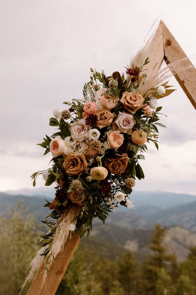 gorgeous floral ceremony arch at a North Star Gatherings Wedding