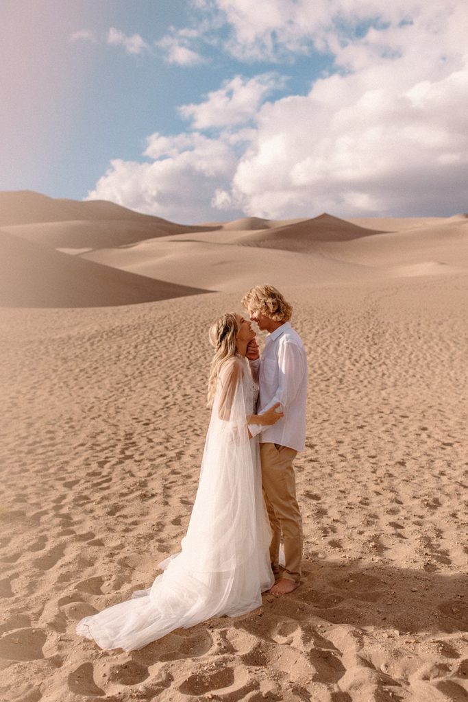 man and woman embracing and smiling in Great Sand Dunes National Park