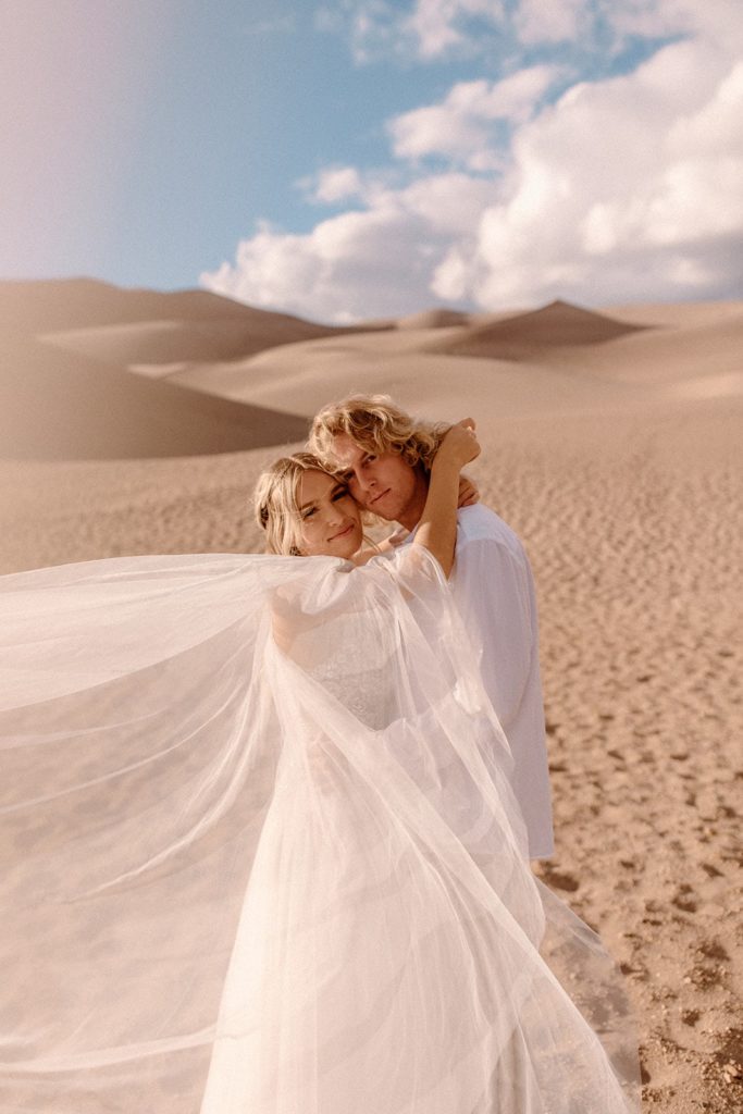 man and woman embracing at Great Sand Dunes National Park
