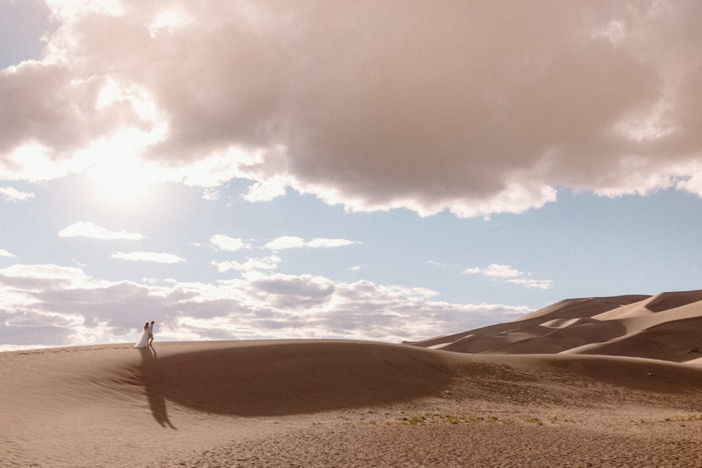 man and woman walking in Great Sand Dunes National Park