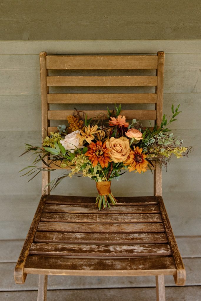 floral bouquet on a rustic chair for a Montana Elopement