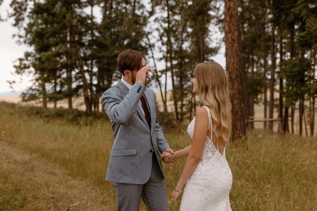 groom crying from seeing his bride for the first time for their Montana Elopement