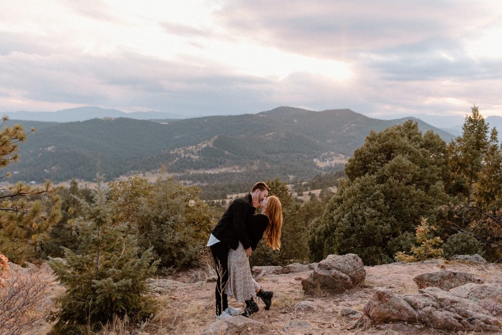 man and woman kissing at Mount Falcon Park for Mountain Engagement Photos
