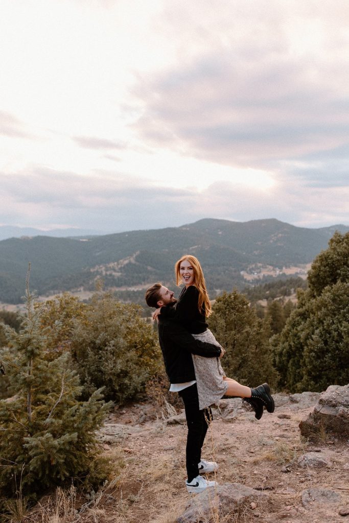 man lifting woman off her feet for Mountain Engagement Photos