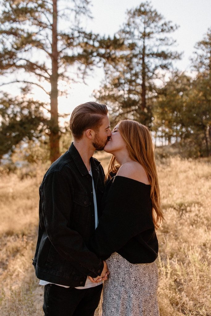 man and woman kissing and holding hands for Mountain Engagement Photos