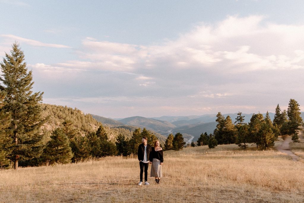 man and woman standing holding hands in Mount Falcon Park for Mountain Engagement Photos