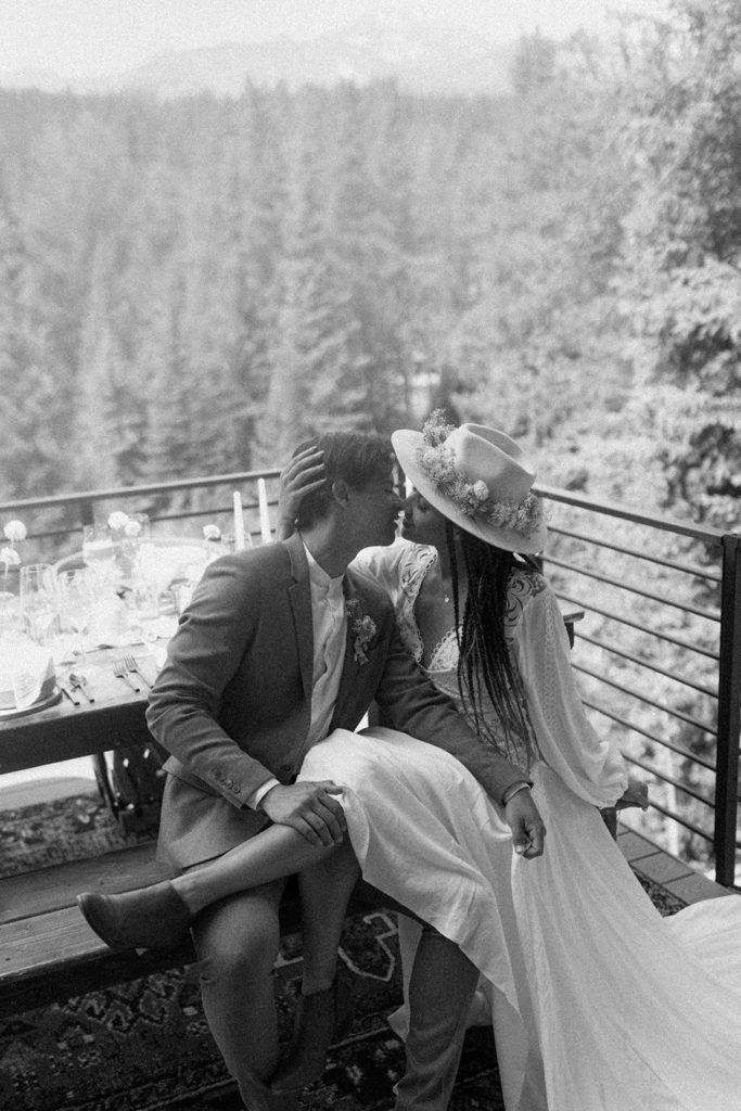 husband and wife embracing at a picnic table on their Colorado elopement day