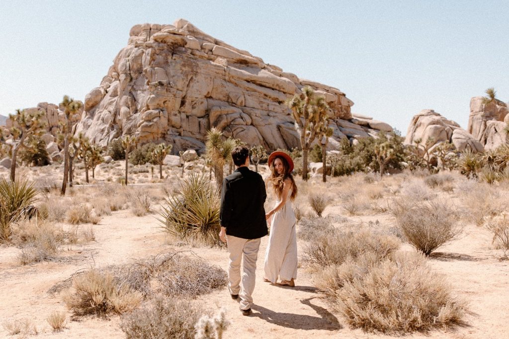 man and woman walking in joshua tree national park