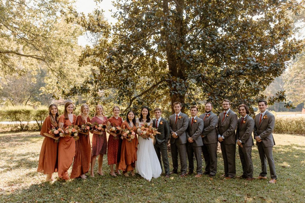 Fall wedding party photos during a backyard wedding.