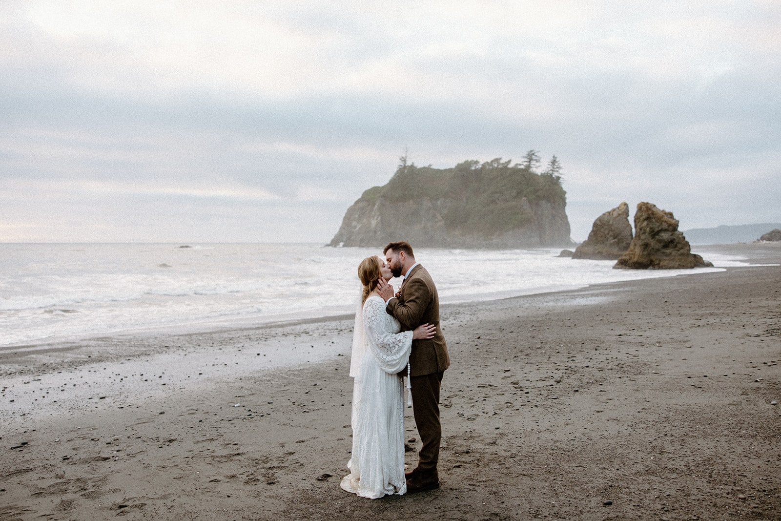 Bride and groom share their first kiss after their ceremony on Ruby Beach in Olympic National Park. This is one of the best places to elope in Olympic National Park!