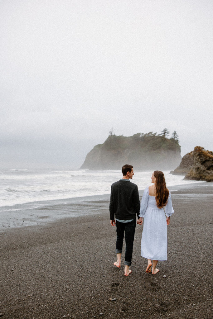 couple walking on the beach for a ruby beach engagement session